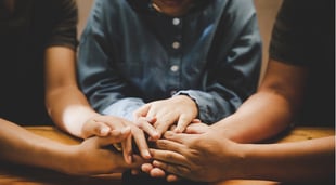 christians praying together over the bible