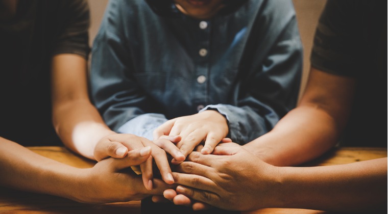 christians praying together over the bible