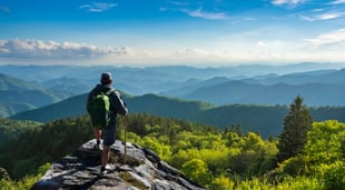 man enjoying view from mountain top